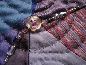Close-up showing buttons and needlework.