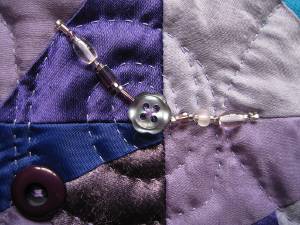 Close-up showing buttons and needlework.
